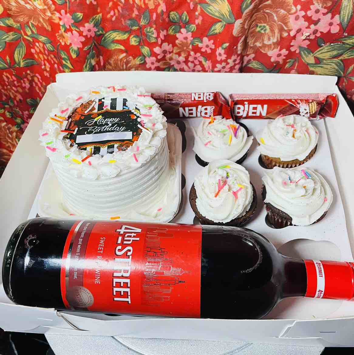 A box of bento cakes &cupcakes with wine